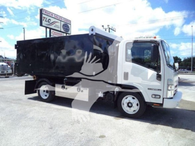 Isuzu NPR-HD truck with a black hooklift bed, white cab, side view showing DOT/owner decals and front wheel.