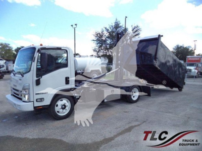 Isuzu NPR-HD truck with a large dump bed in a yard showing stock image watermark and equipment.