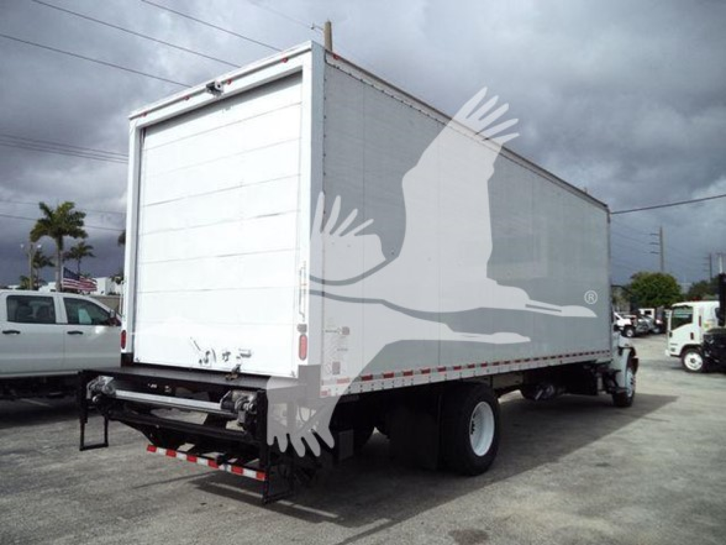 Box truck rear and side view showing cargo area and dual rear wheels.