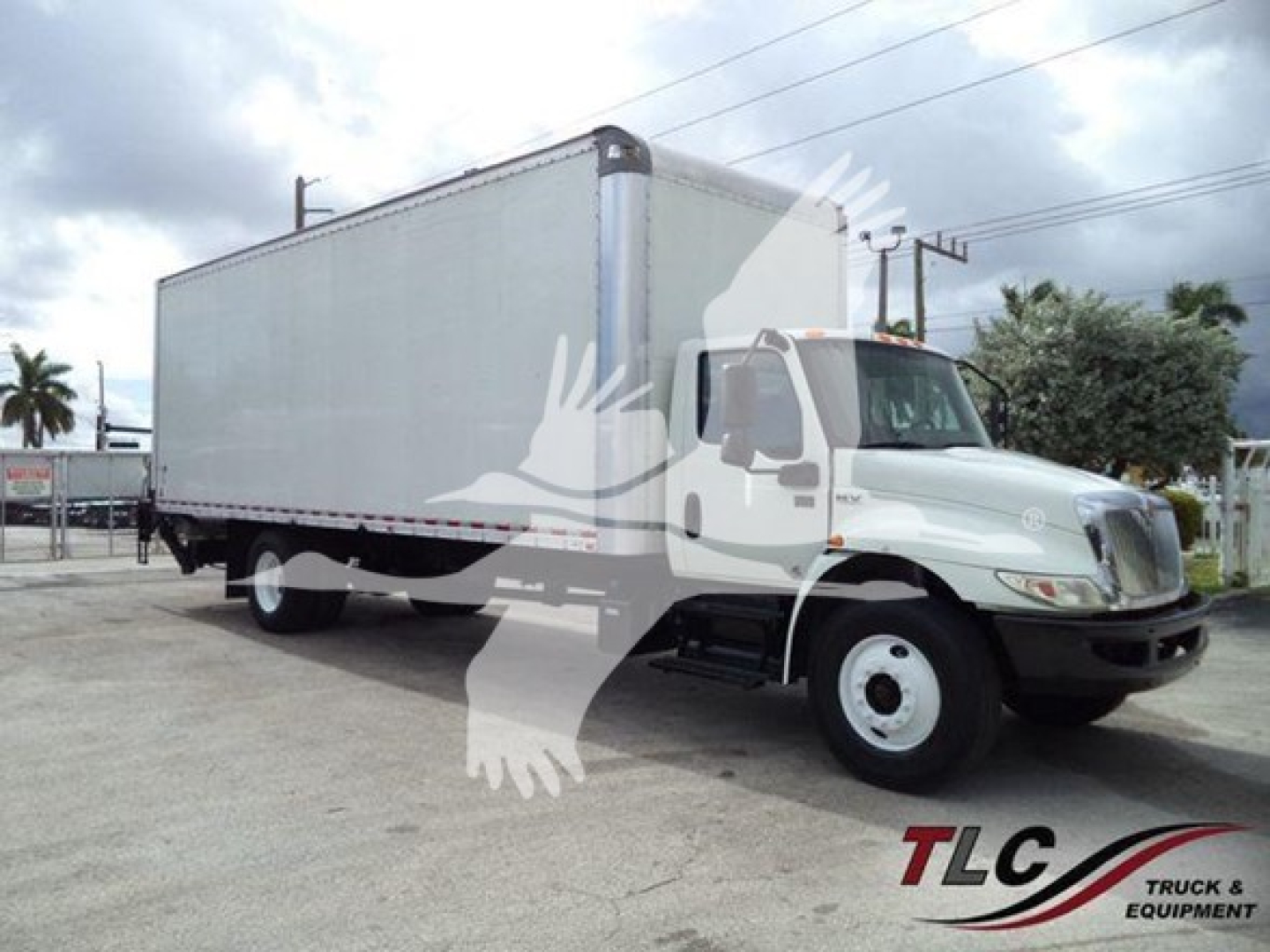 Box truck from a side angle showing a large box cargo area, International truck visible, stock overlay watermark partially covering.