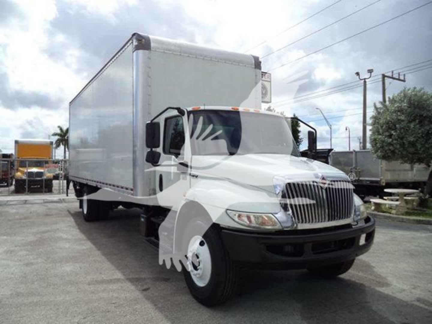 Box truck showing 2020 International MV with a large rectangular box body and white cab.