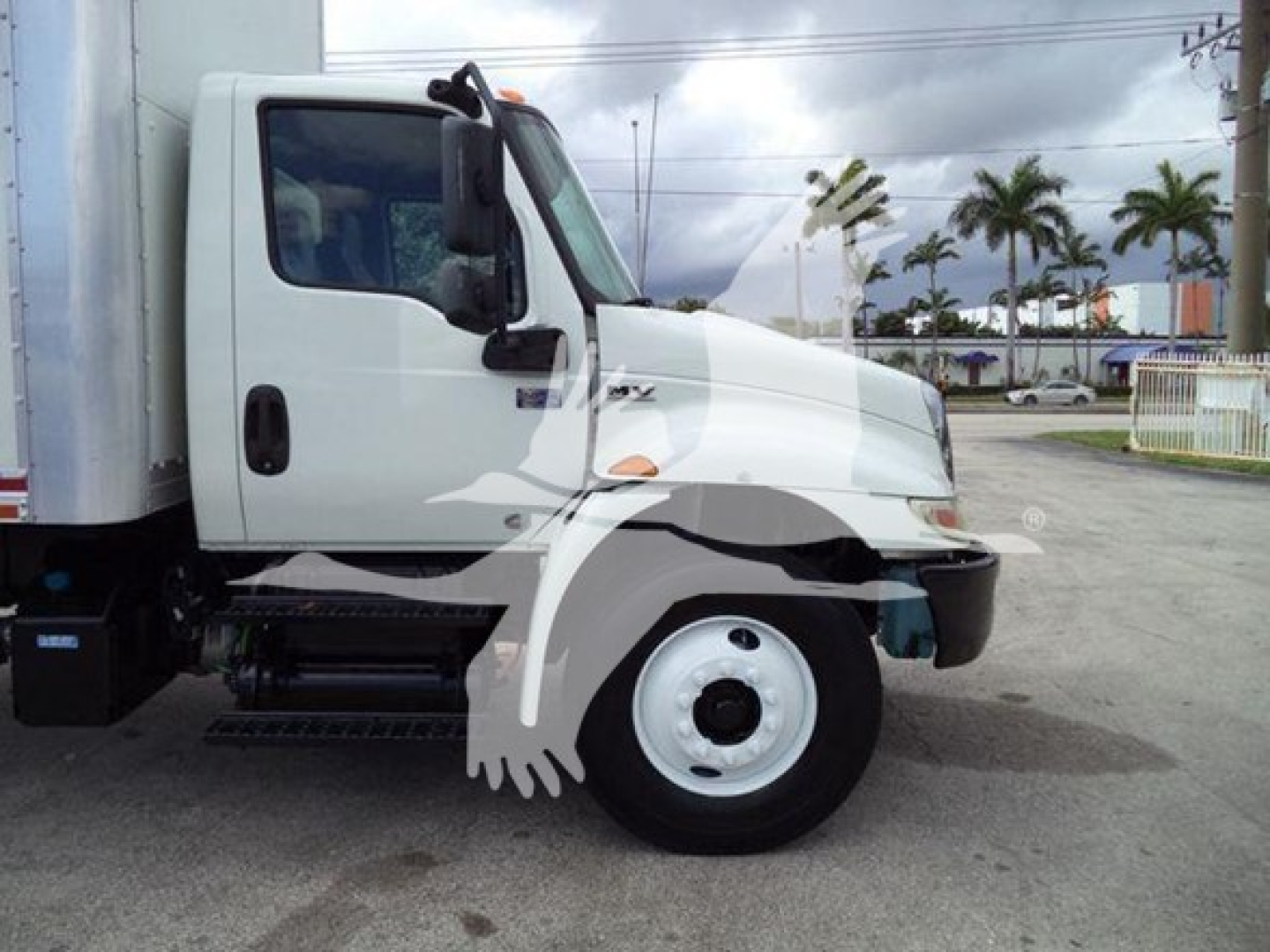 Drive side view of a 2020 International MV box truck showing front wheel, cab, and cargo box with stock number T29270.