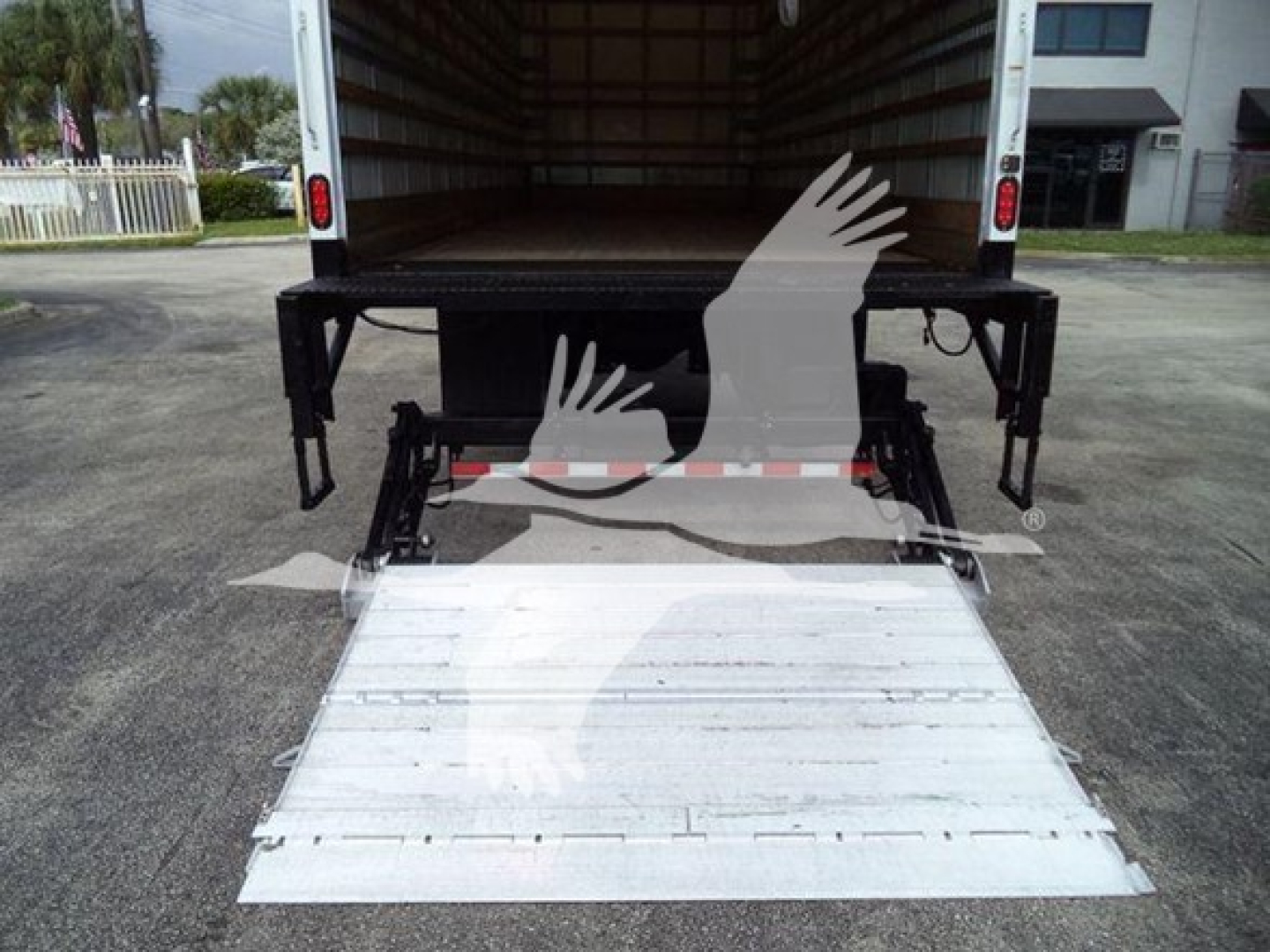 Truck with ramp lowered showing loading platform; empty cargo area; no visible labels or text on the interior walls.