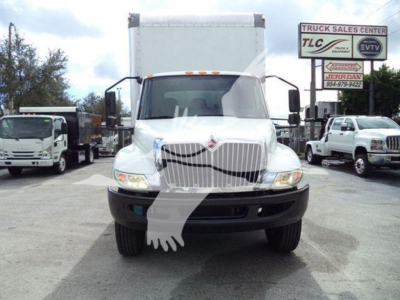 Truck front view of a 2020 International MV with a box body, daytime running lights, large grille, and white cab.