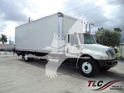 Box truck from a side angle showing a large box cargo area, International truck visible, stock overlay watermark partially covering.