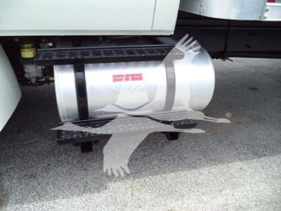 Truck side view showing fuel tank undercab and steps with a sticker; no legible model text visible.