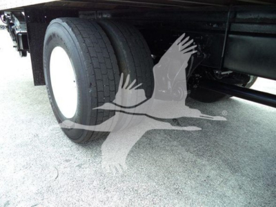 Truck chassis side showing dual rear tires and undercarriage with wheels and frame visible.