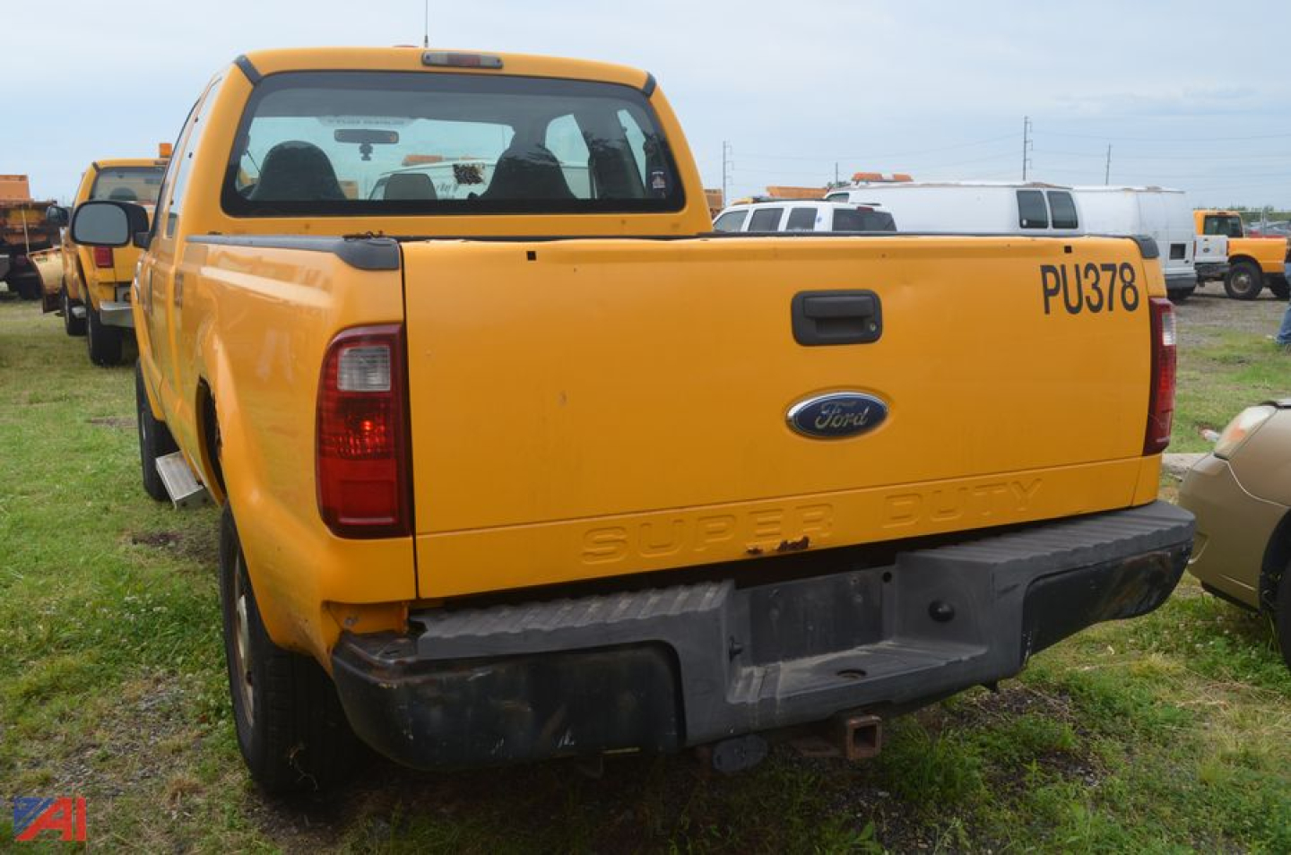2008 Ford F-250 Super Duty extended cab pickup truck rear view in yellow showing tailgate and bumper.