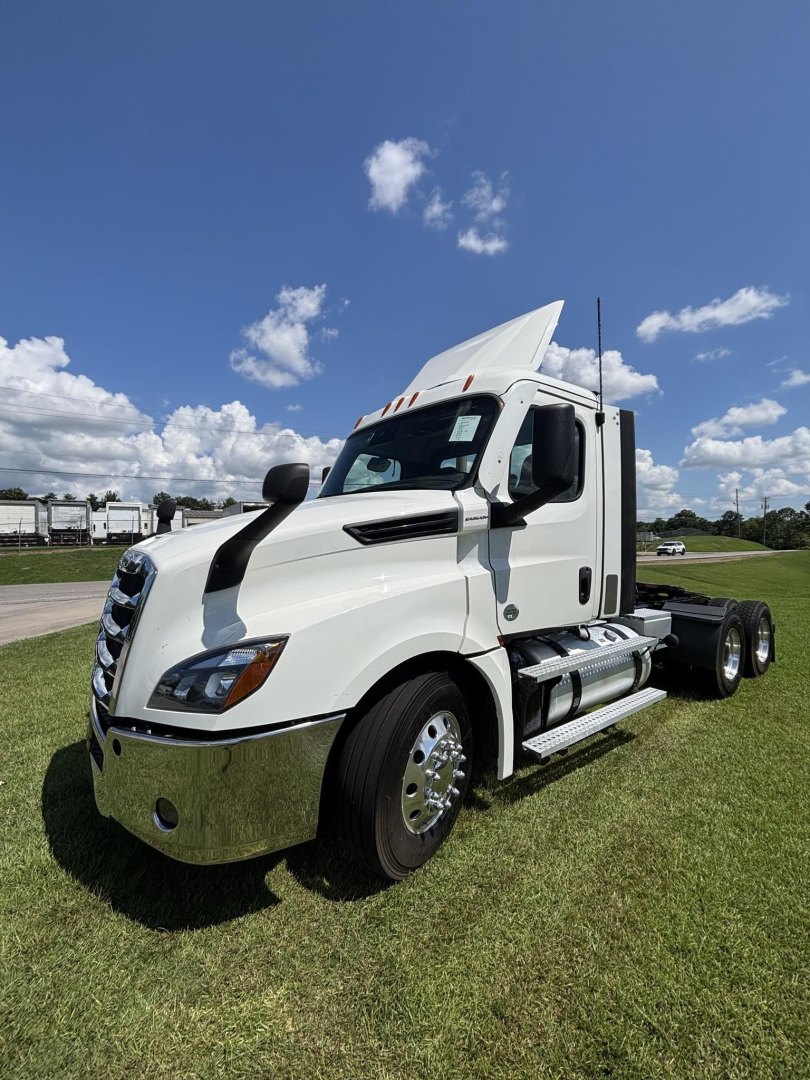 Freightliner Cascadia 126 daytime cab tractor in white with sleeperless cab, chrome bumper, dual rear axles, visible exhaust stack and fuel tanks.