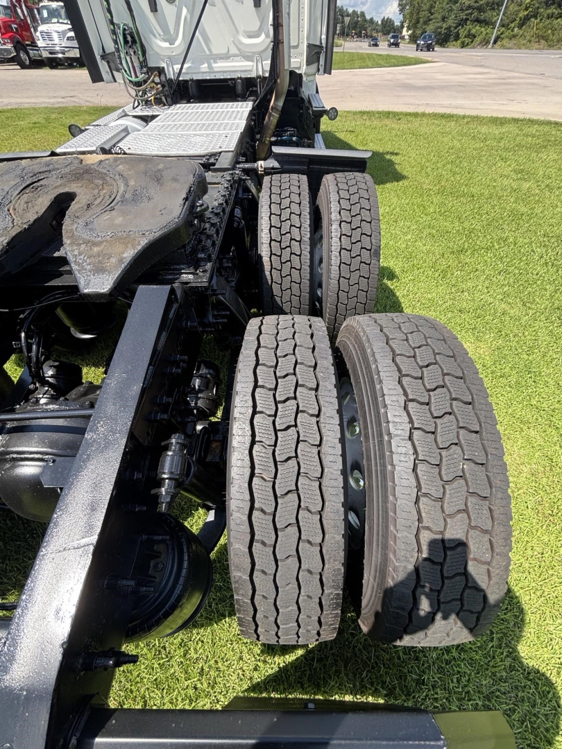 Tractor trailer rear chassis and dual rear axles of a 2021 Freightliner Cascadia 126 showing tires and suspension components.