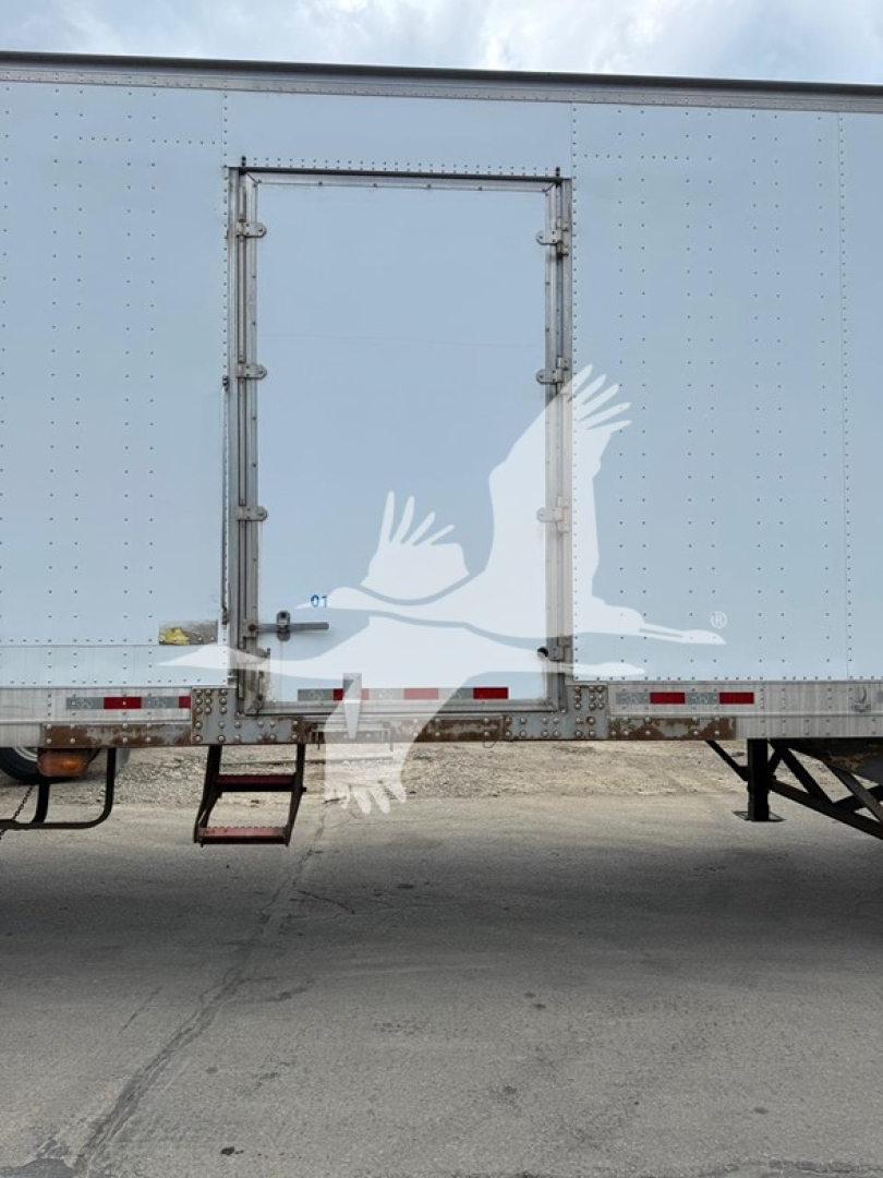 Great Dane trailer rear view showing swing door and side door with steps and reflective tape.