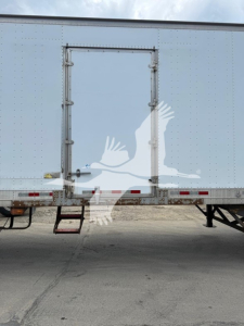 Great Dane trailer rear view showing swing door and side door with steps and reflective tape.