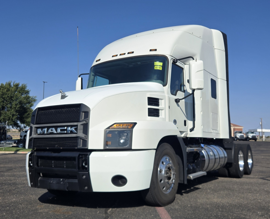 White 2020 Mack Anthem conventional sleeper truck side view showing cab, grille with MACK logo, chrome fuel tanks, and dual rear axles.