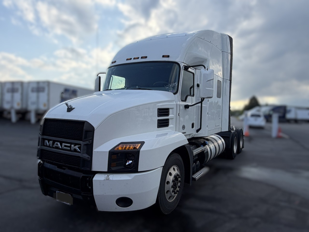 Tractor truck cab from a 2020 Mack Anthem, white outer with black grille, showing front-left view and sleeper cab.
