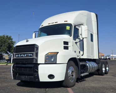 White 2020 Mack Anthem conventional sleeper truck side view showing cab, grille with MACK logo, chrome fuel tanks, and dual rear axles.