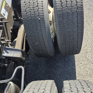 Dual rear tires of a 2020 Mack Anthem sleeper truck showing tread pattern and axle assembly visible.