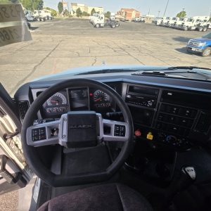 Trucker’s cockpit of a 2020 Mack Anthem with steering wheel, dashboard gauges, and center console visible.