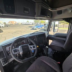 Mack Anthem truck interior cockpit showing steering wheel and dashboard with visible controls