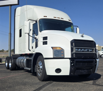 Truck cab exterior of a white Mack ANTHEM truck, front-right view, with black grille and large side mirrors.