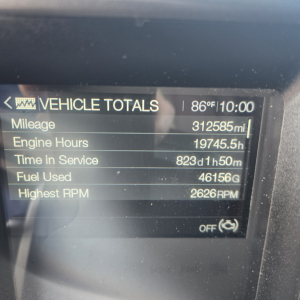 Vehicle totals screen in a Mack Anthem showing mileage 312585 mi, engine hours 19745.5 h, time in service 823d 1h 50m, fuel used 46156 gal, highest RPM 2626 RPM.