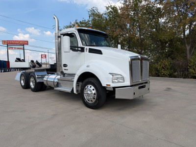 Kenworth T880 daycab truck in white, side view showing front grille, dual rear axles, and chrome fuel tanks; no visible text on labels.