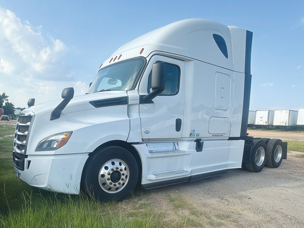 Freightliner Cascadia126 sleeper cab tractor in white, side view, showing front grille, driver door, and rear tandem wheels.