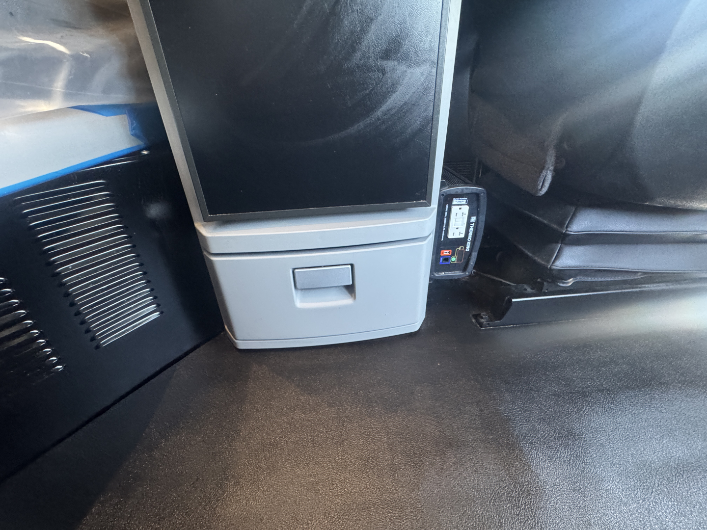 Kenworth T680 interior dash area with a small display and control panel; visible text includes nothing legible beyond generic components.