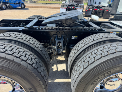 Kenworth T680 chassis with dual rear axles and large tires, view of fifth wheel mounting and frame, no cab or engine visible.
