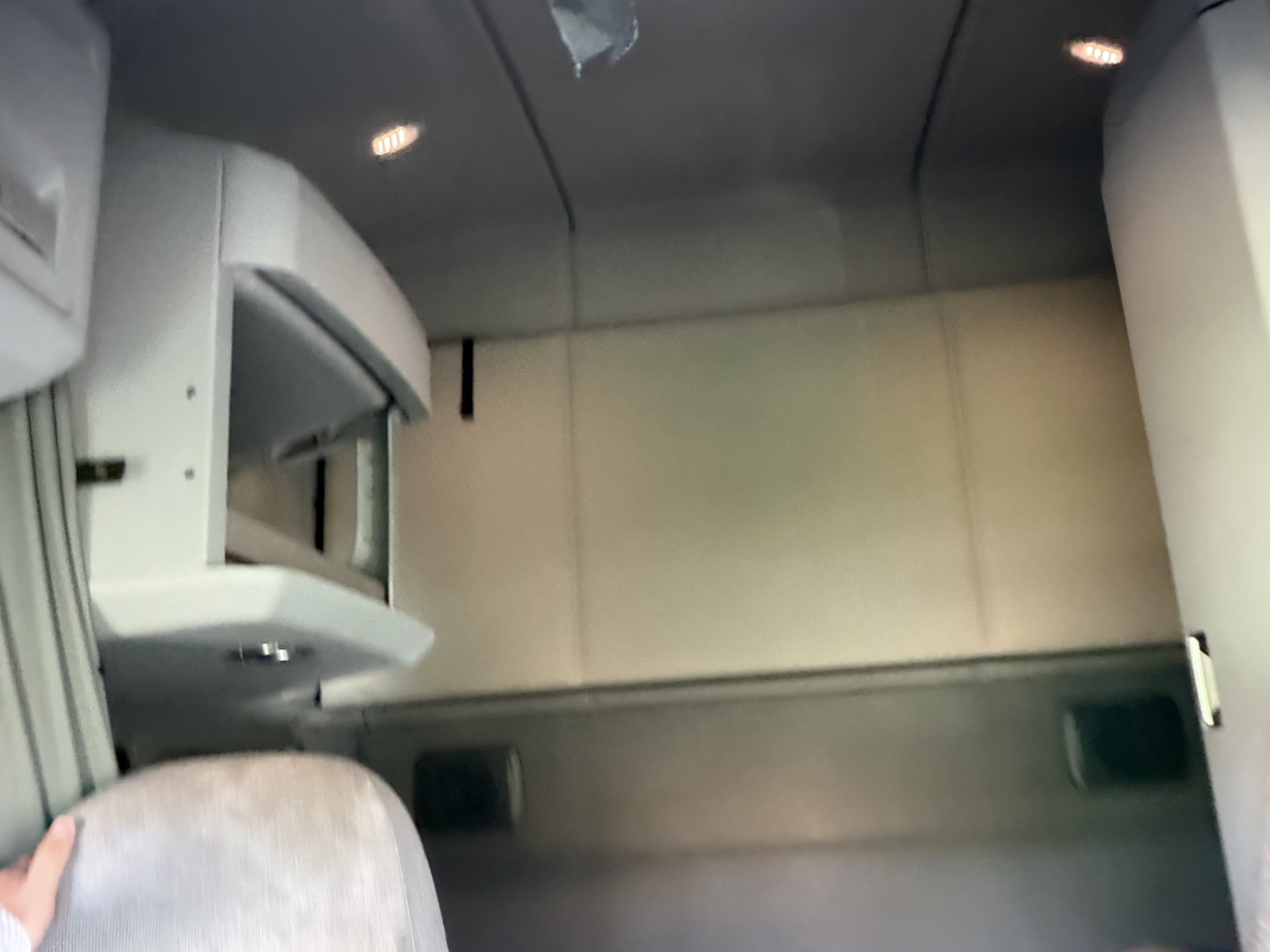 Kenworth T680 interior cabin with storage shelves and overhead console visible.