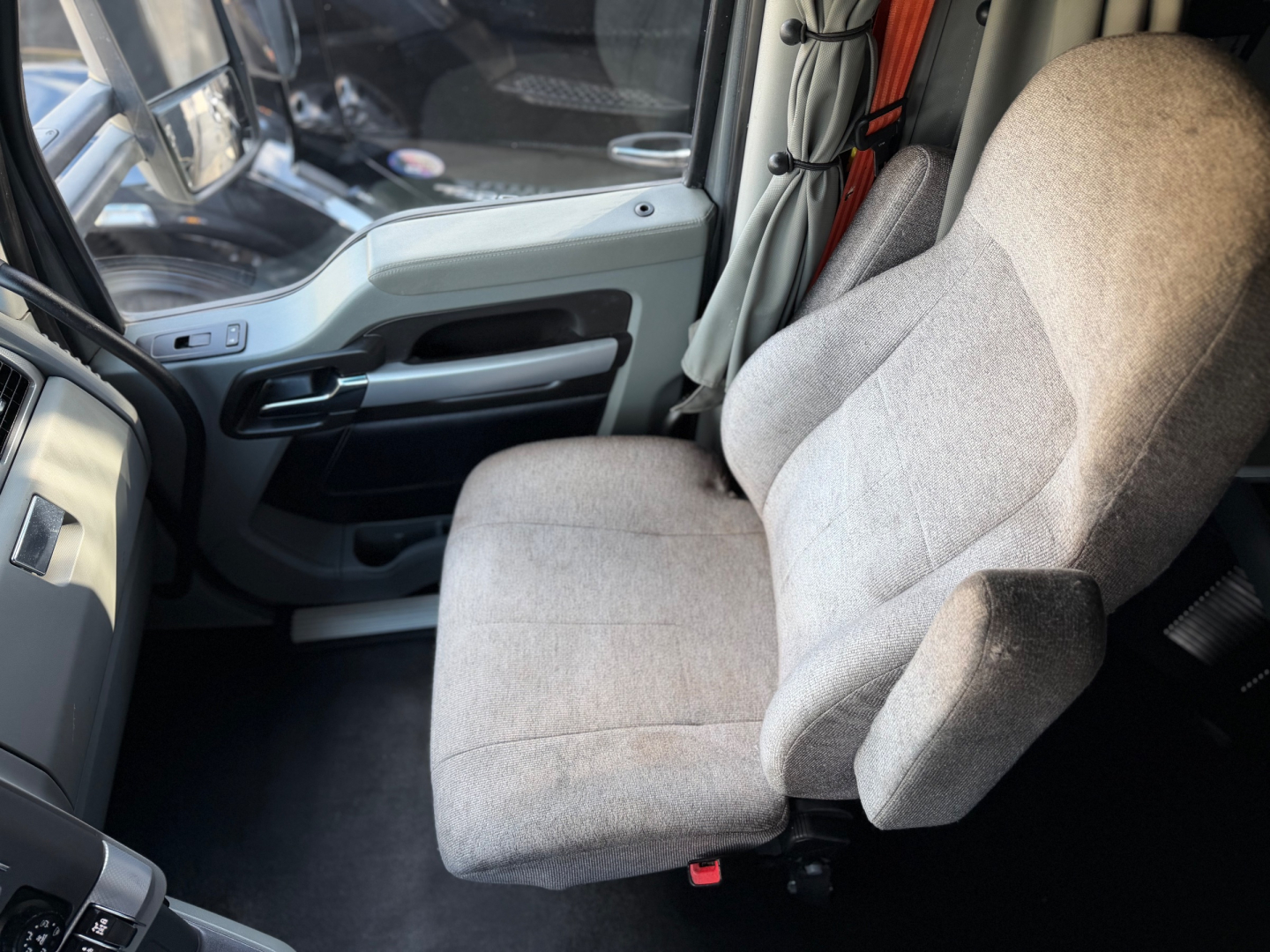 Truck interior seat and door panel showing driver's seat and steering area
