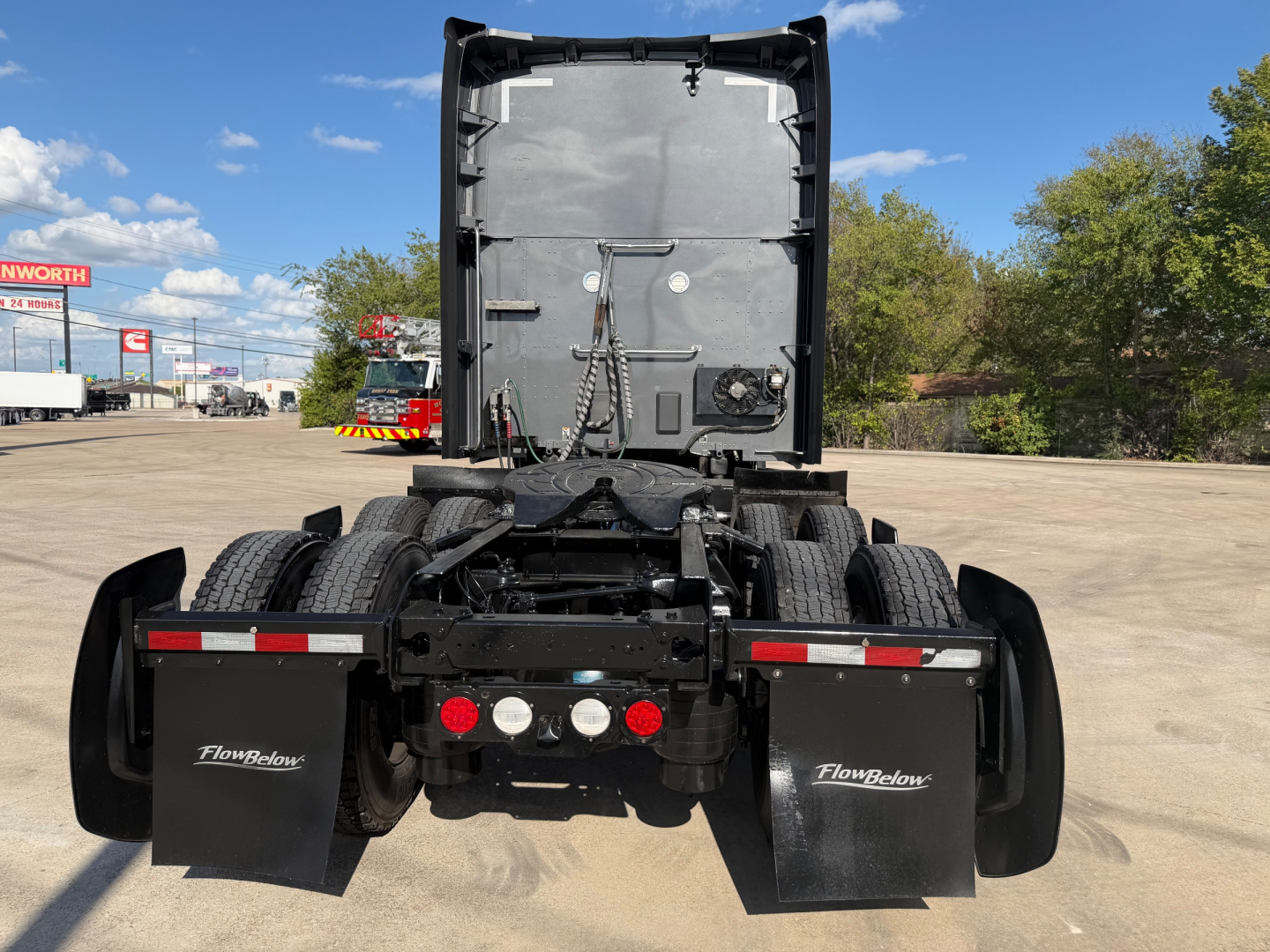 Kenworth T680 rear view showing chassis and mudflaps with FlowBelow hoods and lights near bumper