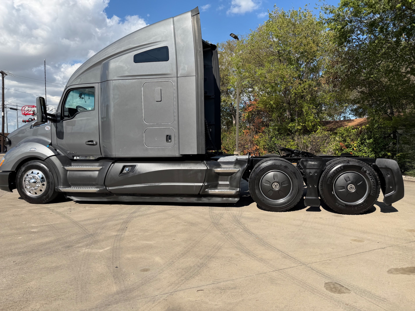Kenworth T680 conventional sleeper truck side view showing cab, chassis, and dual rear axles with alloy wheels.