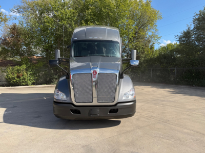 Kenworth T680 truck front view showing large chrome grille and headlights.