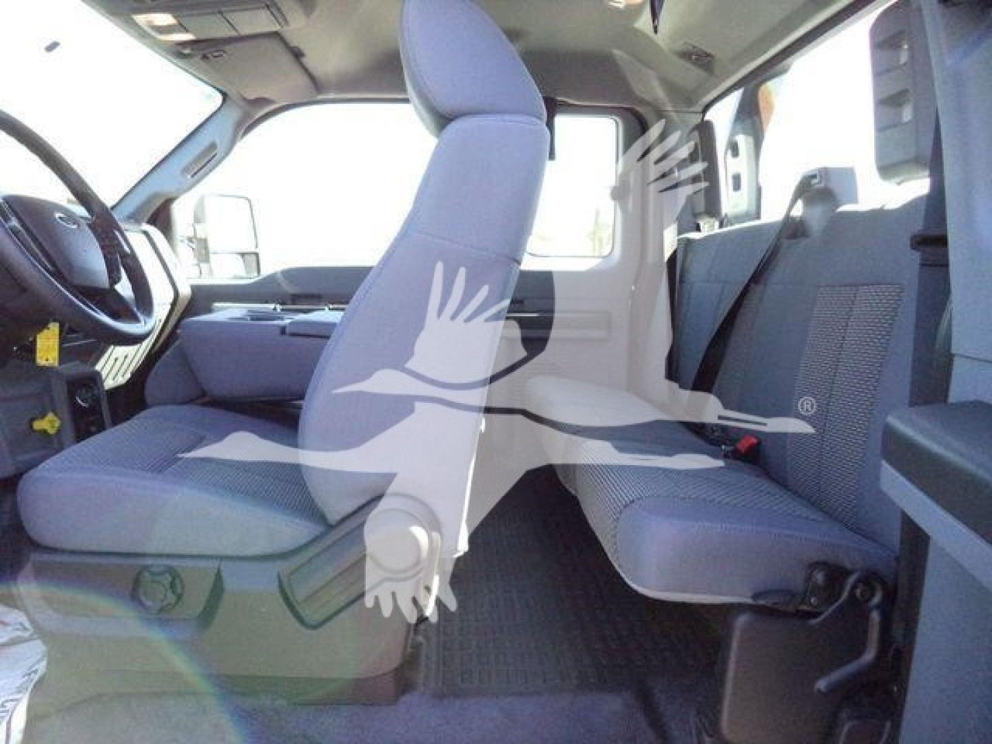Interior of a 2024 Ford F750 Sd rollback truck showing front bench seat and rear seating with gray upholstery.