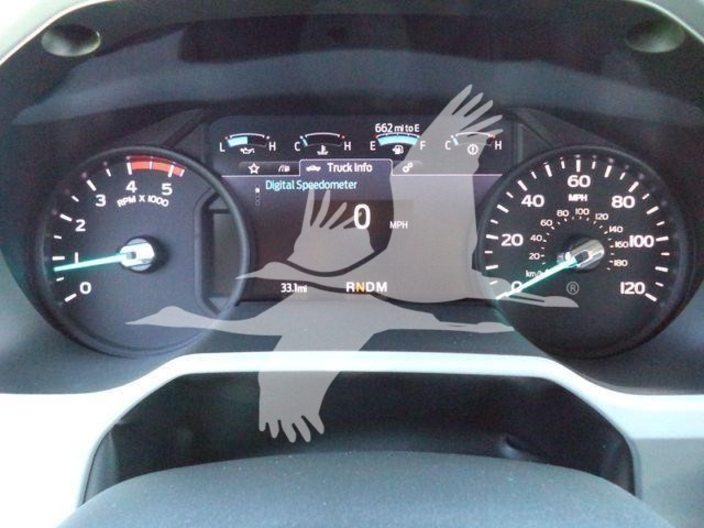 Ford F-750 cockpit dash with digital display showing 0 MPH, gauge clusters, and gear selector; truck info overlay; white overlay watermarks.