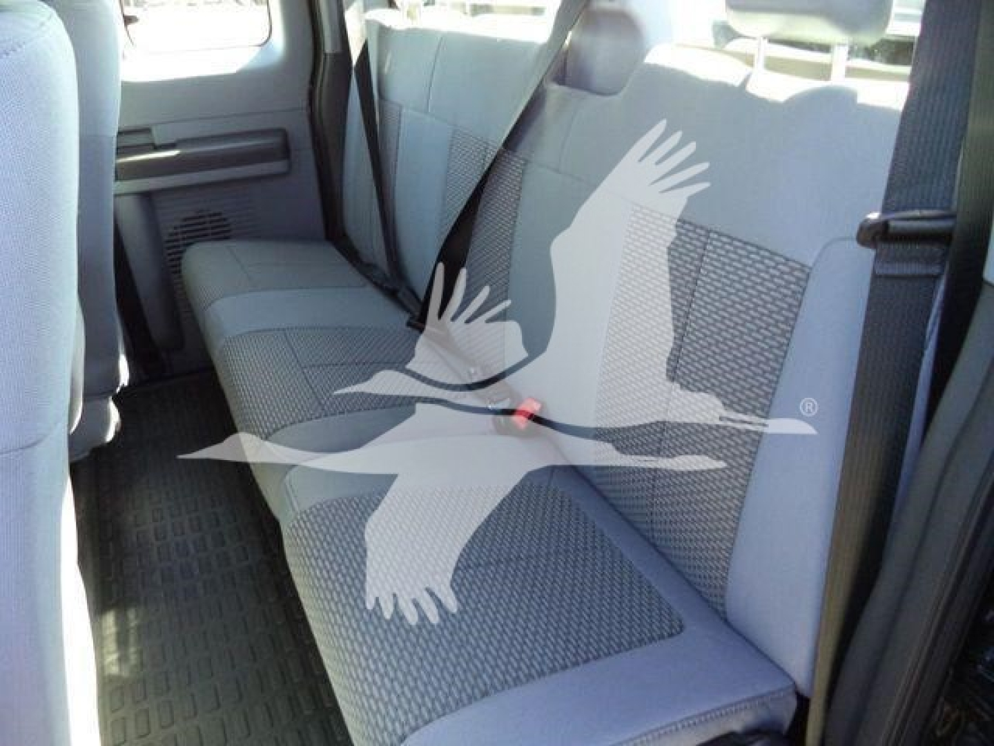 Ford F-750 rollback truck interior rear seat view with gray fabric seats.