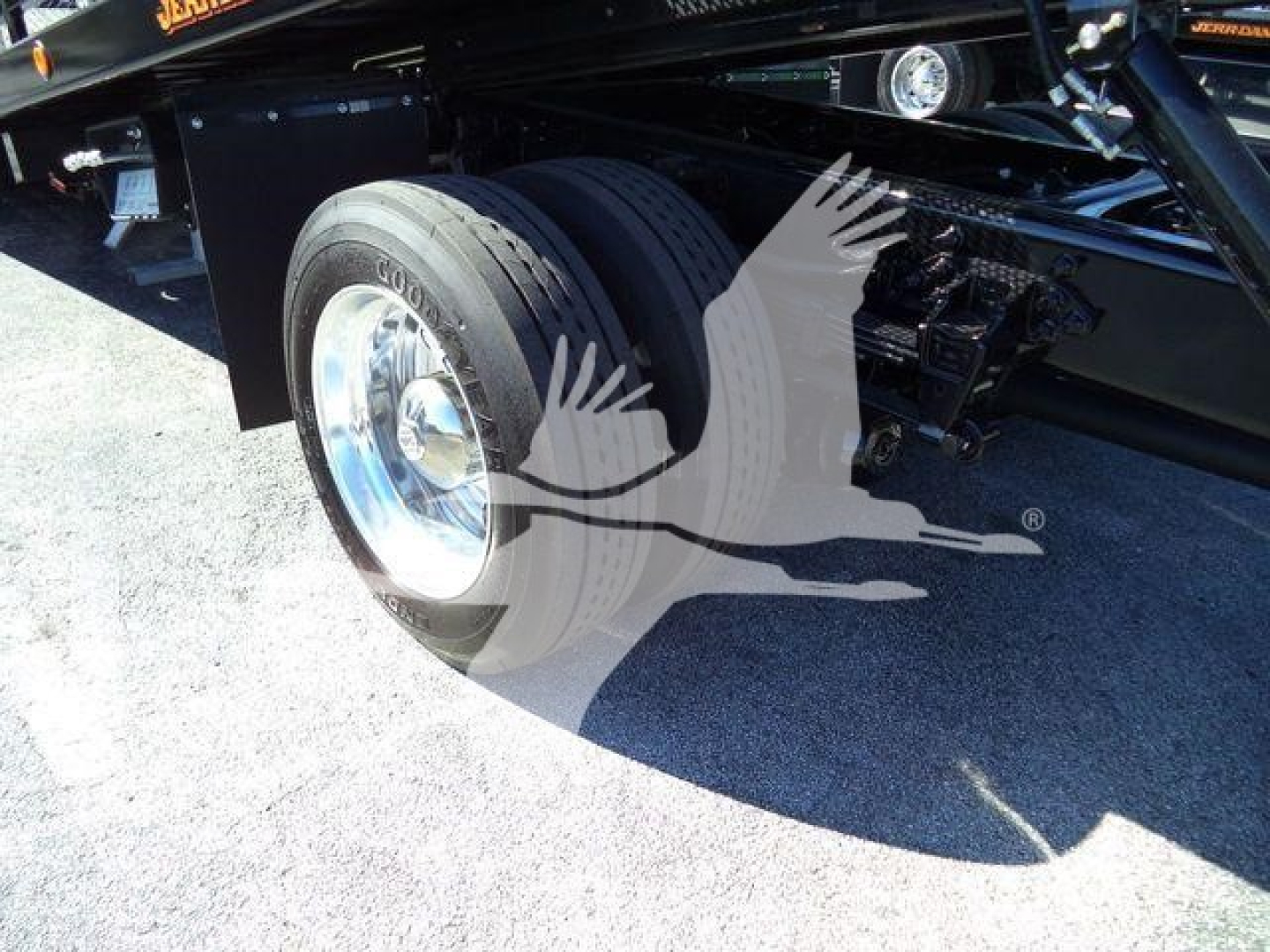 Ford F750 rollback truck rear dual rear wheels and suspension visible.