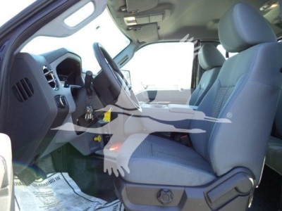 Ford F750 cab interior showing driver seat and front passenger seat with steering wheel and dashboard visible