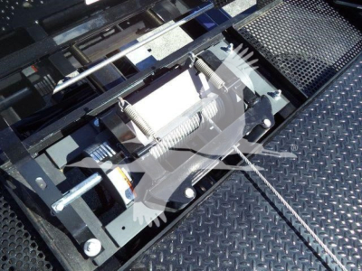 Ford F750Rollback truck component view showing hydraulic winch mechanism and steel grating platform