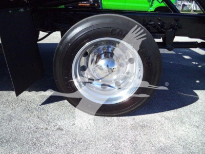 Ford F750 rollback truck wheel showing Goodyear tire and polished steel rim.
