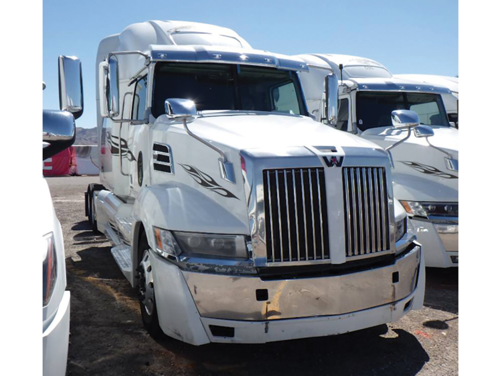 Truck front view showing 2020 Western Star 5700XE sleeper cab with chrome grille and bumper.