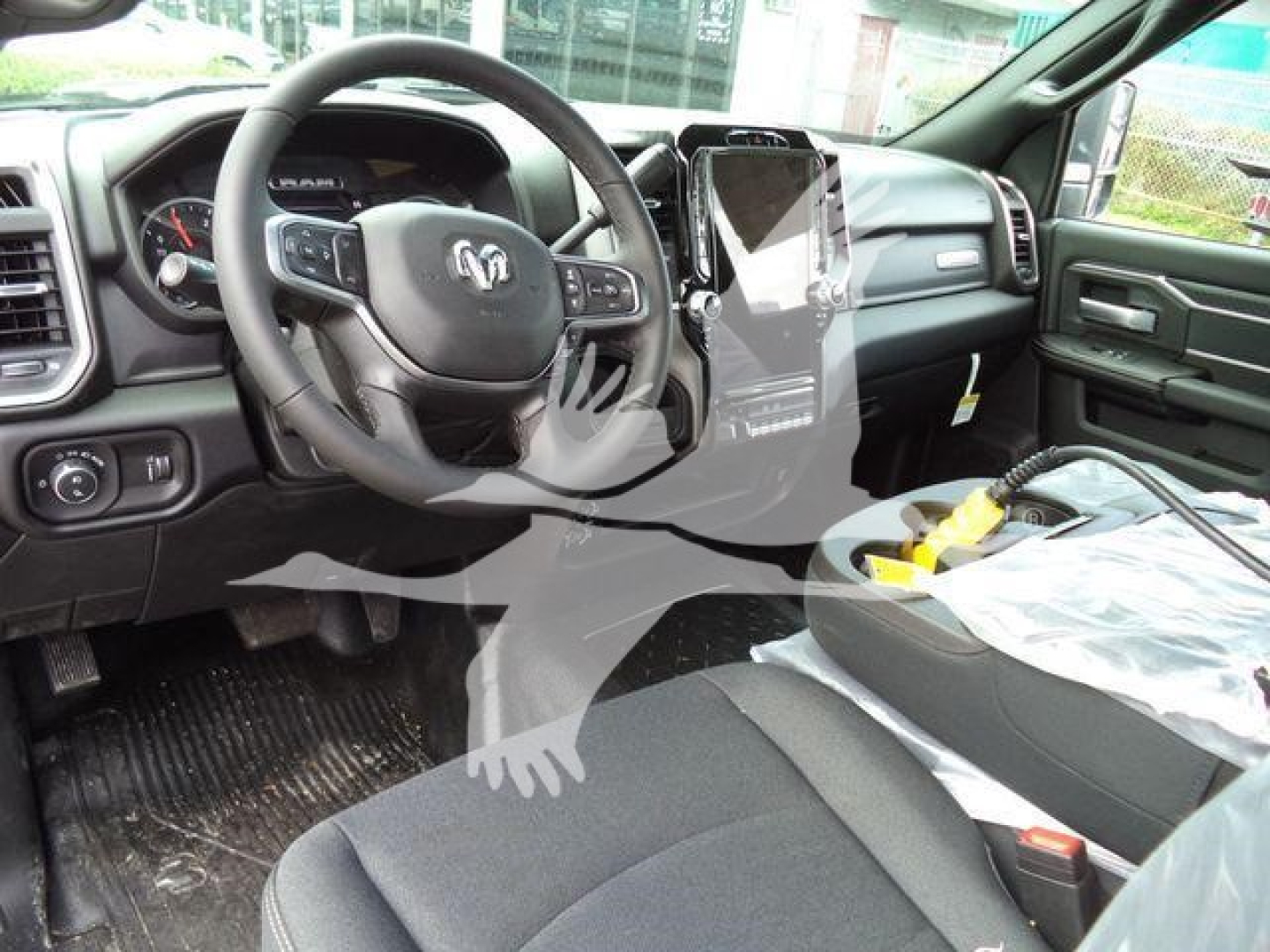 Interior of 2026 Ram 4500 Big Horn truck showing steering wheel, dashboard, center touchscreen, and front seats.