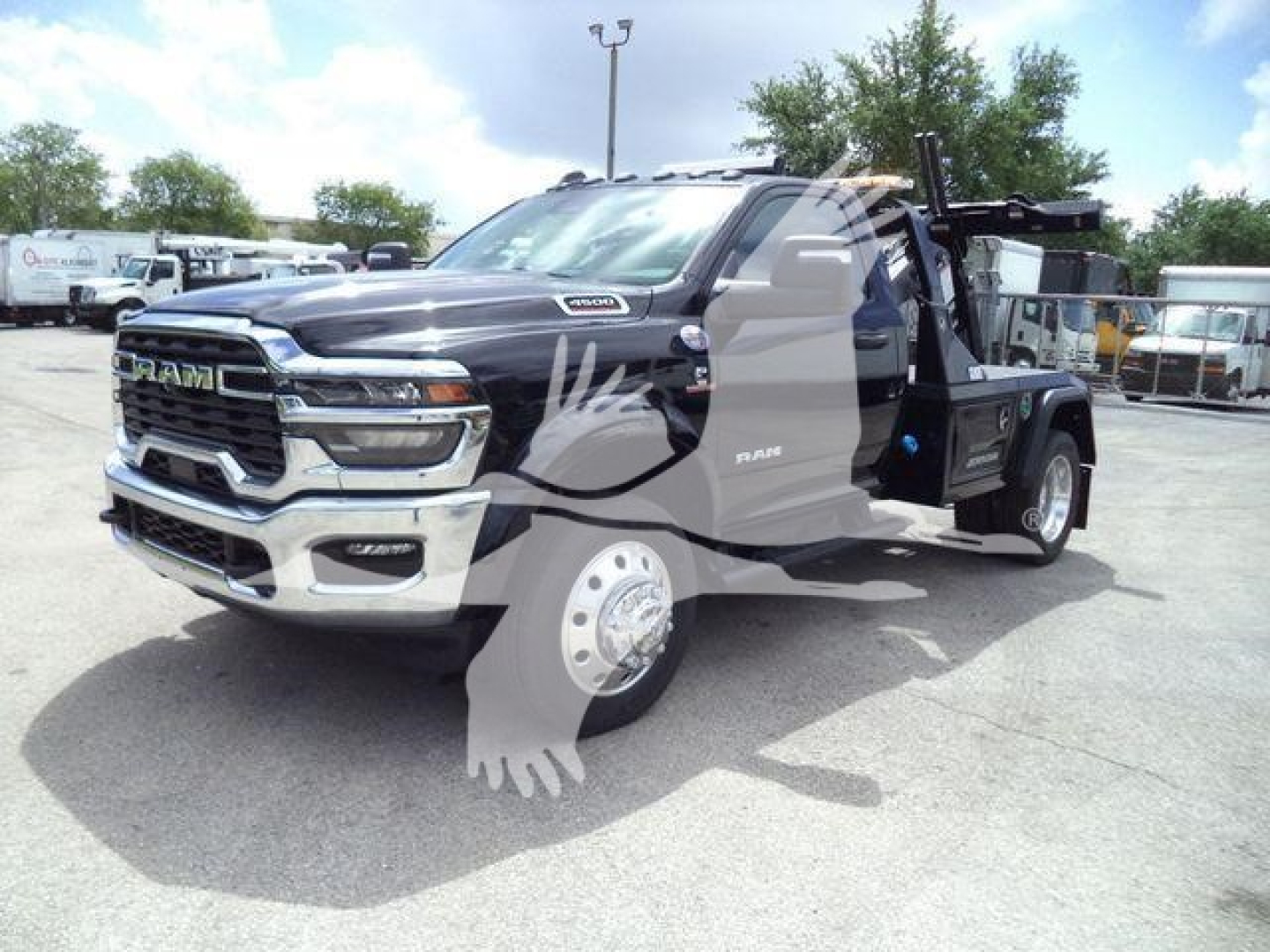 Ram 4500 pickup truck in a dealership lot with towing bed and winch attachment visible