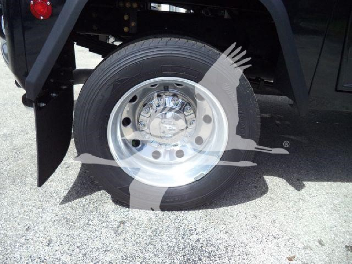 Ram 4500 wheel and tire close-up showing polished steel rim and tire on truck; part of rear wheel well visible.