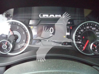 Ram instrument cluster with digital display showing 0 mph, gauges on left and right, RAM logo at top center.