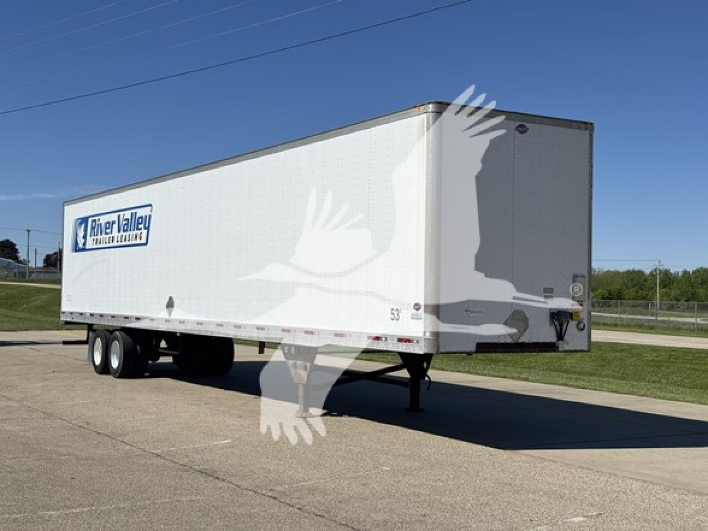 Trailer side view showing River Valley trailer logo on a white utility box trailer with dual rear axles and gooseneck hitch.