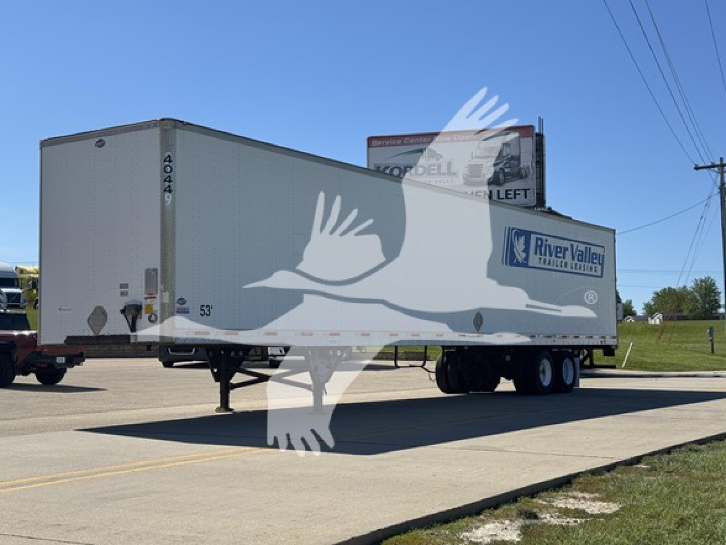 Trailer side view showing River Valley Trailers logo and rear door, with axle and dual wheels, 53' length, VIN tag visible.