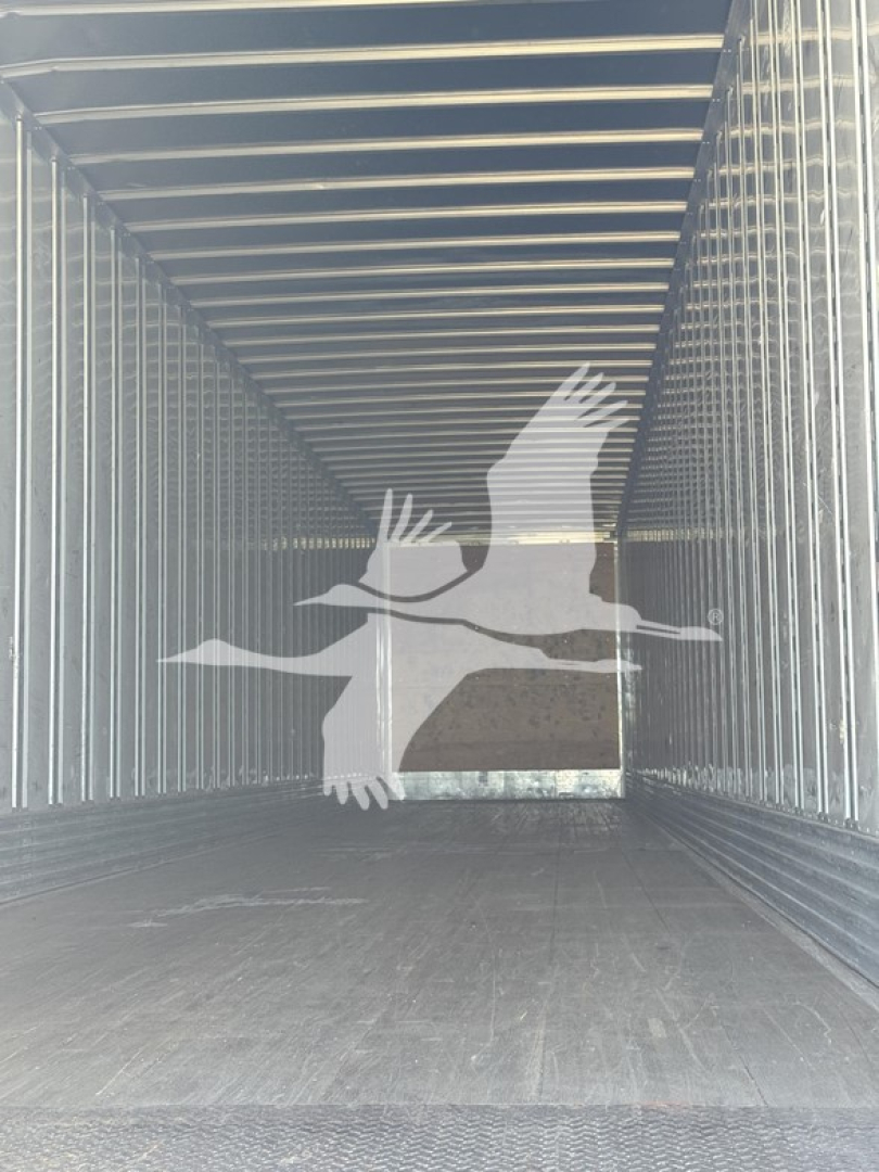 Trailer interior showing empty cargo space with steel walls and ceiling of a utility trailer.