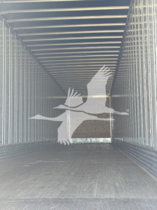 Trailer interior showing empty cargo space with steel walls and ceiling of a utility trailer.