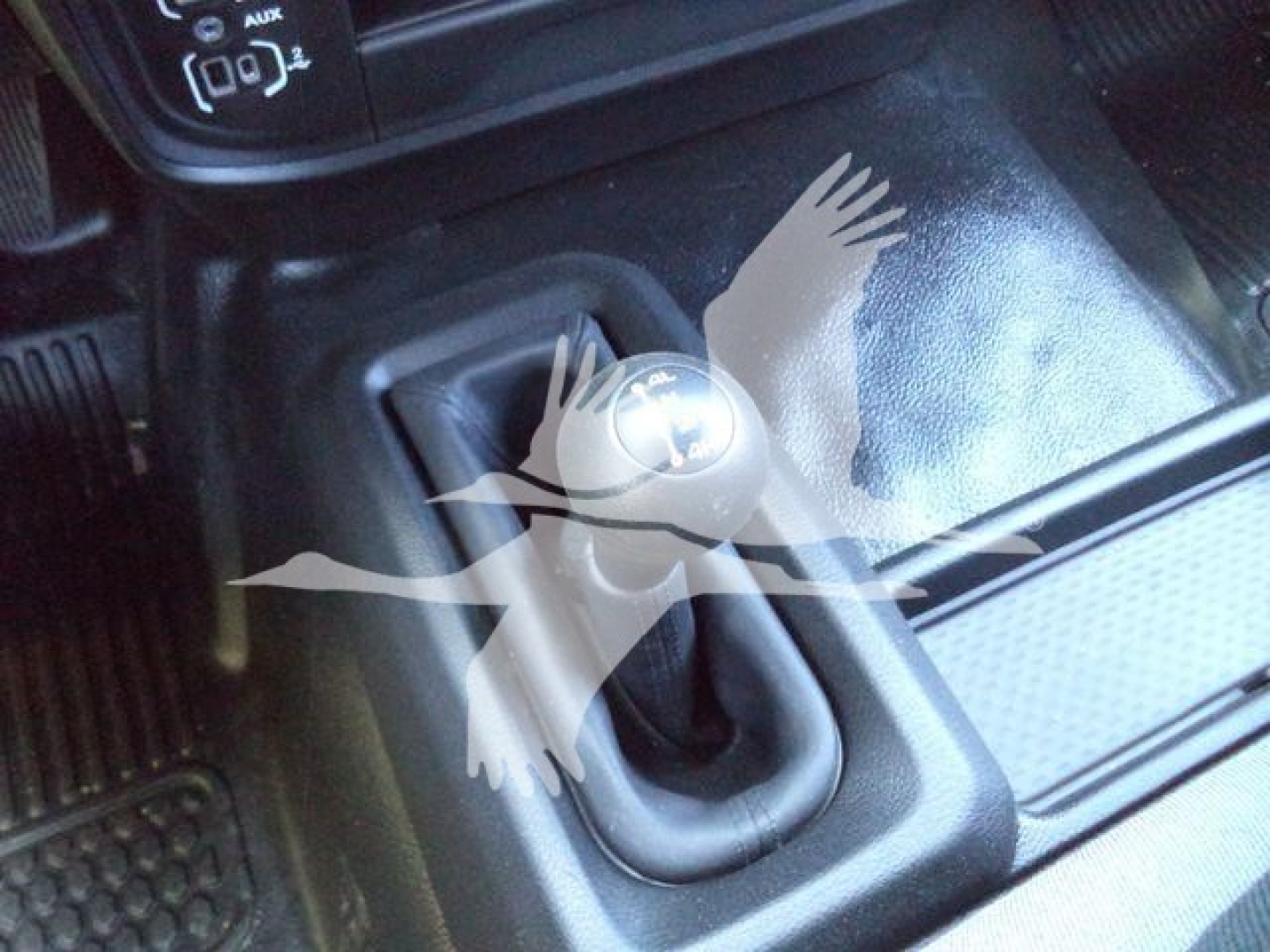 Ram 4500 interior center console with 6-speed or gear shift lever and control panel; visible text: AUX, OFF, and other small icons around the gear area.
